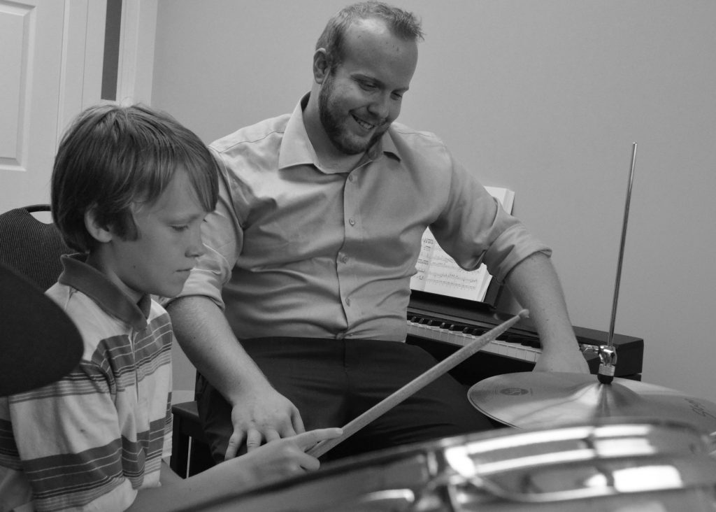 Stephen teaching with student, drums